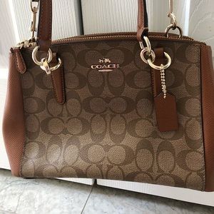 Brown coach “C” pattern cross body bag with silver hardware